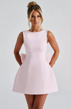 Short women's dress with decorative bow at the back