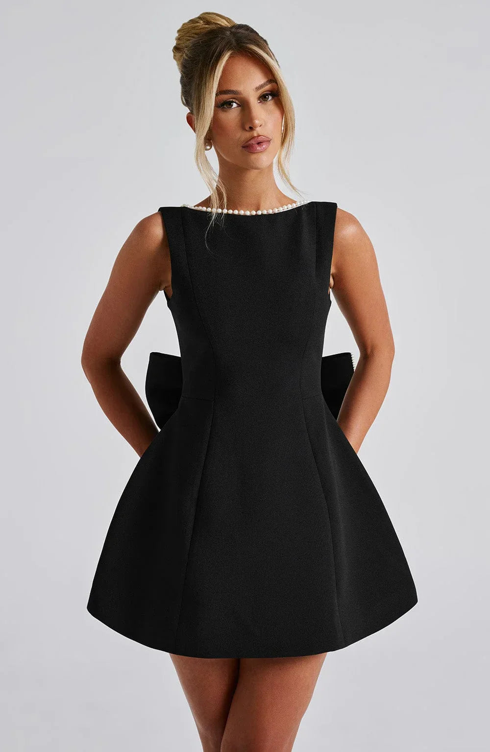 Short women's dress with decorative bow at the back