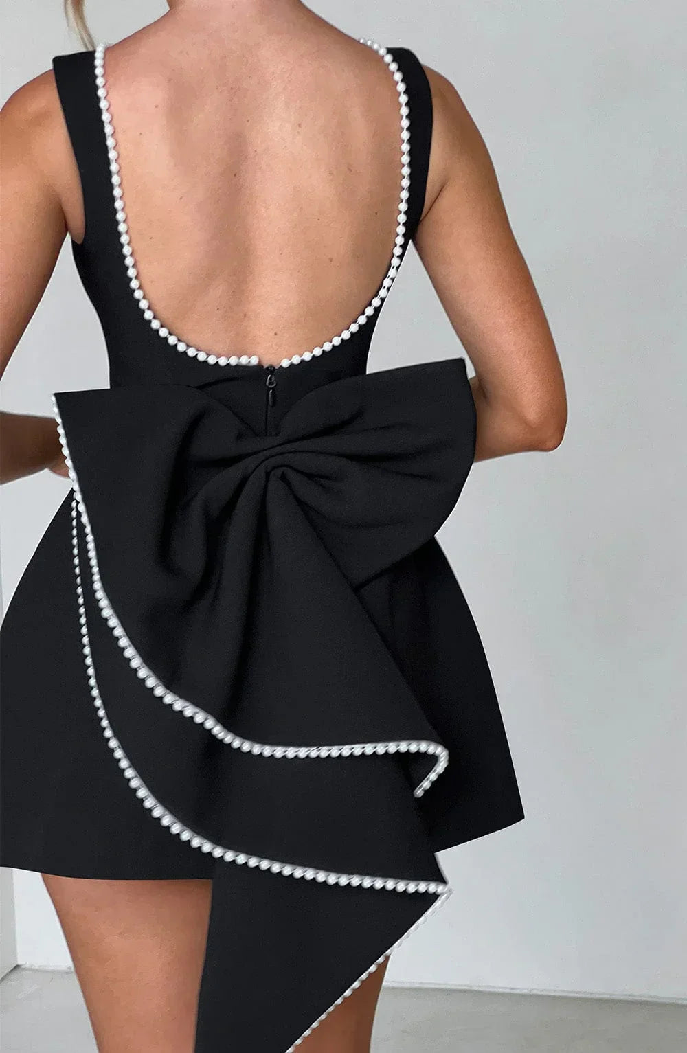 Short women's dress with decorative bow at the back