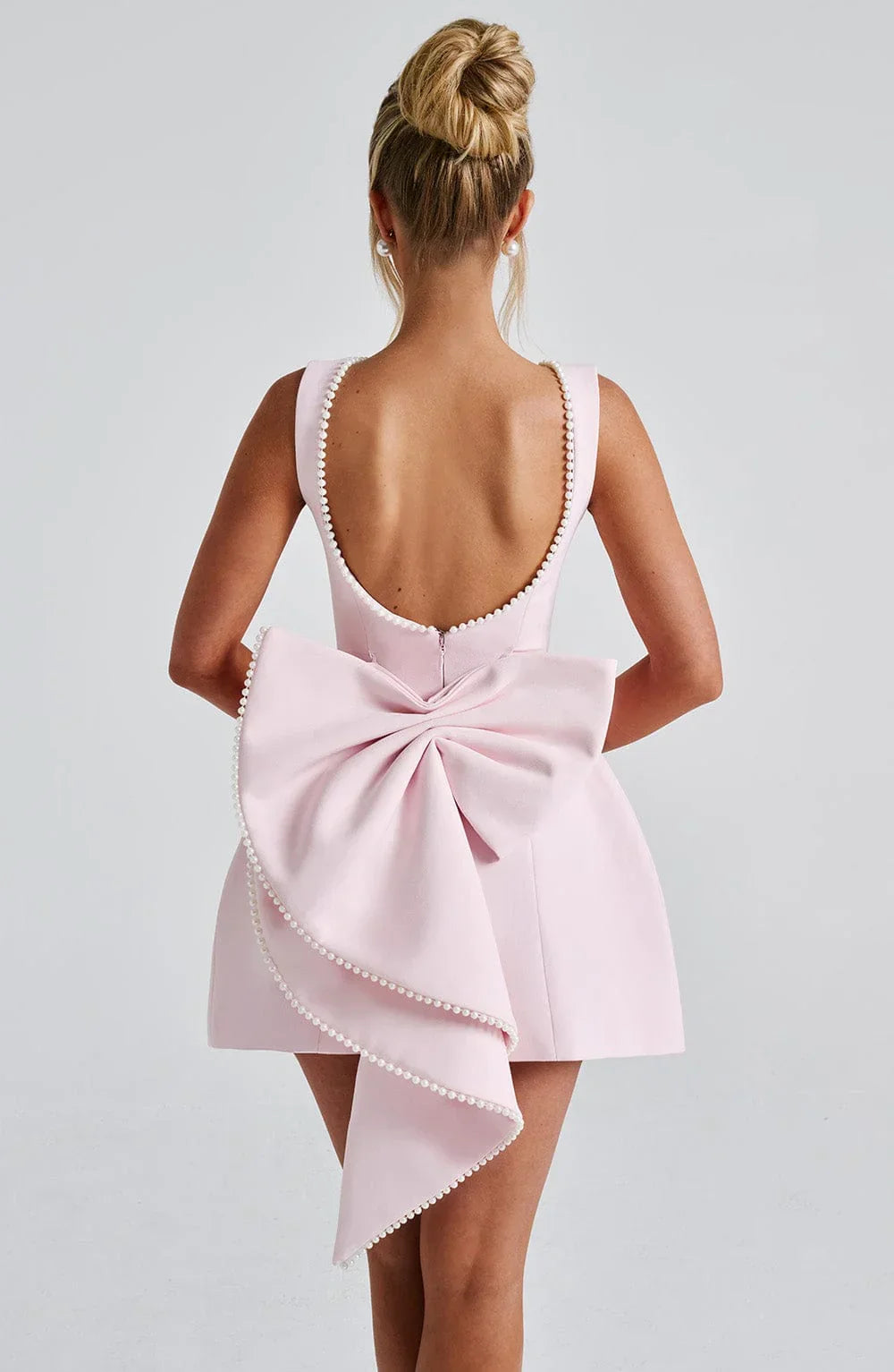 Short women's dress with decorative bow at the back