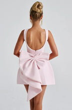 Short women's dress with decorative bow at the back