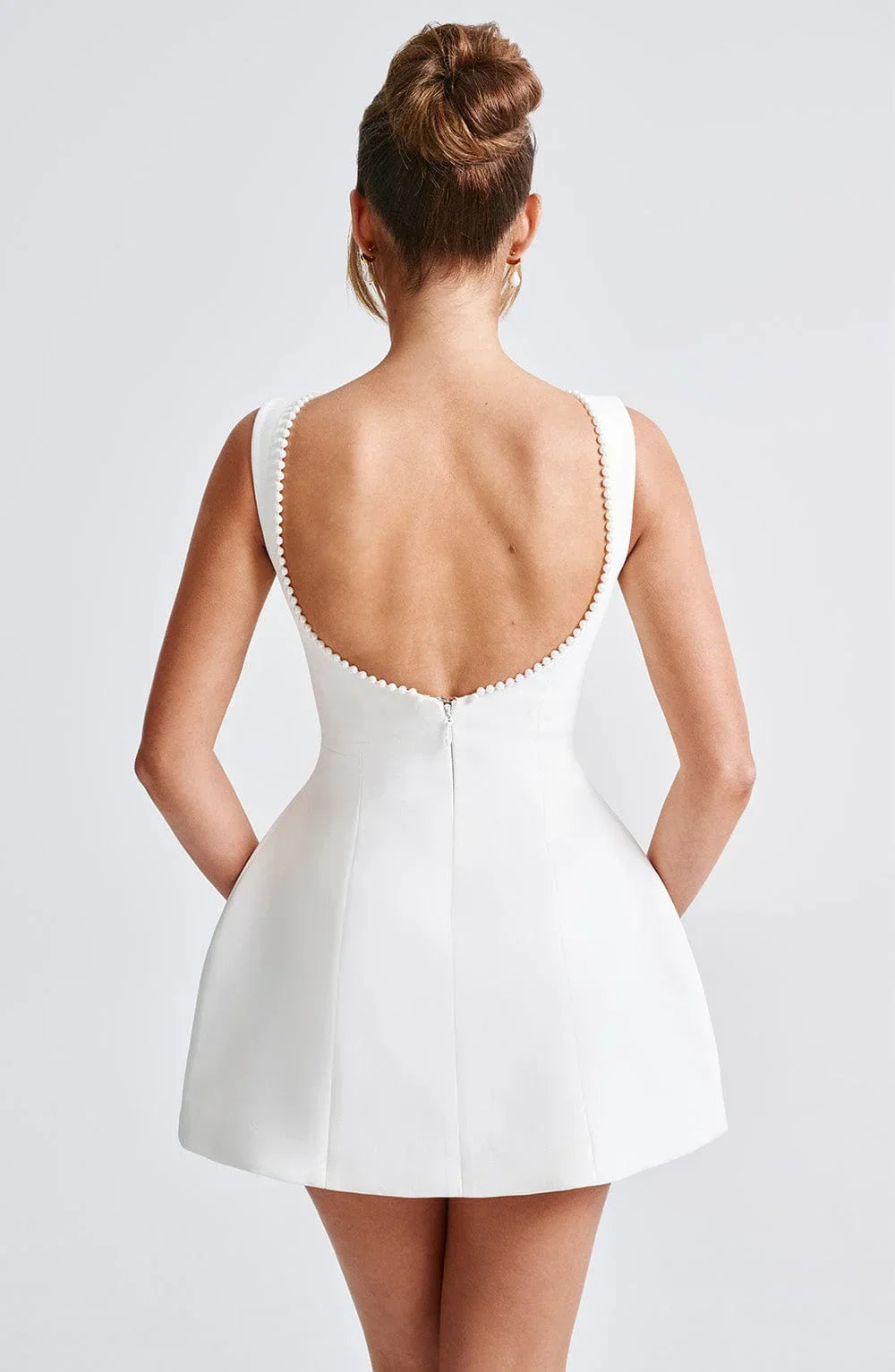Short women's dress with decorative bow at the back