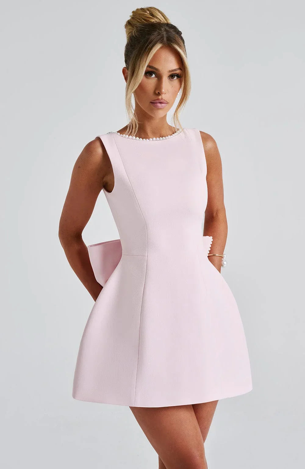 Short women's dress with decorative bow at the back
