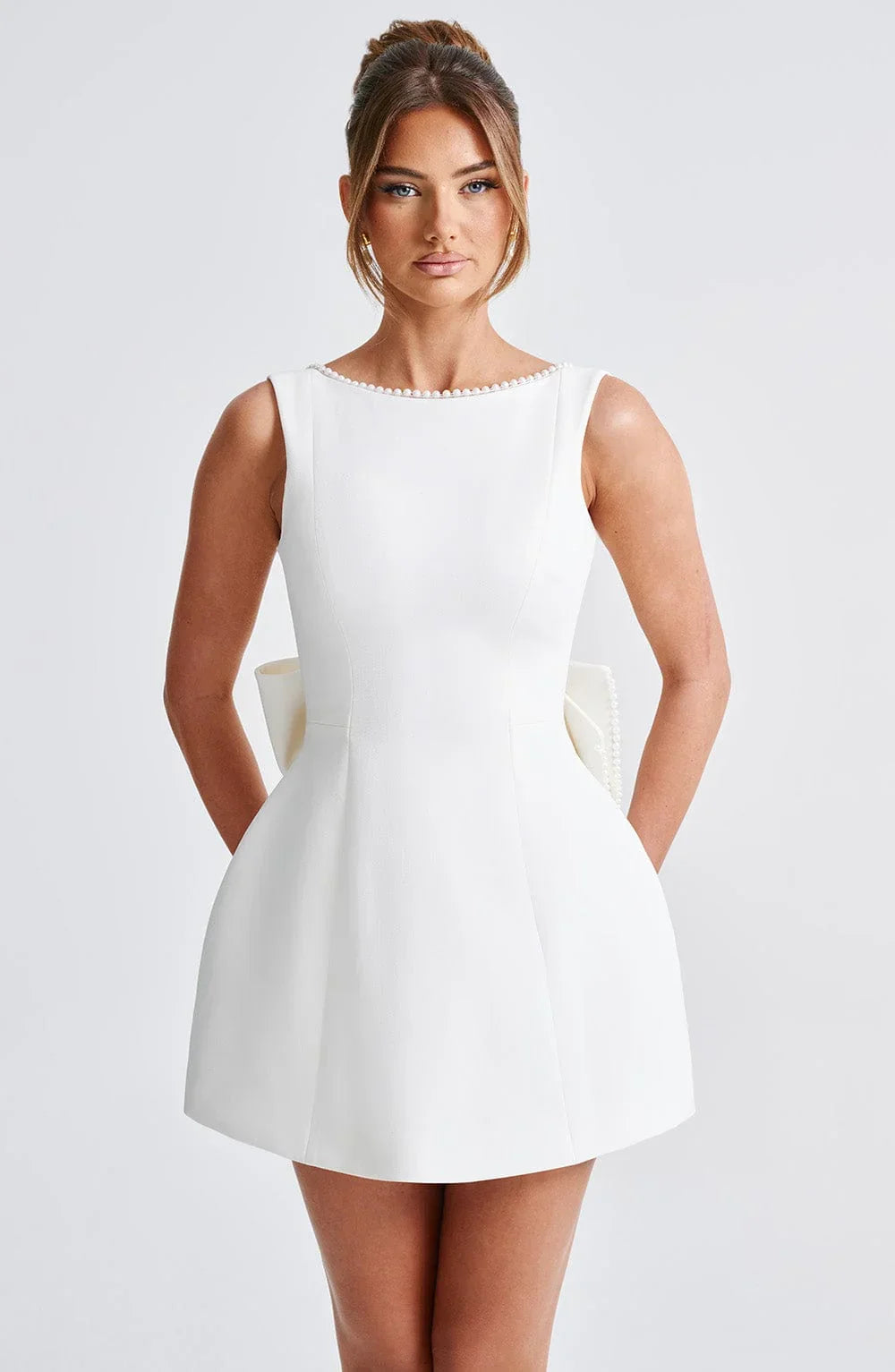 Short women's dress with decorative bow at the back