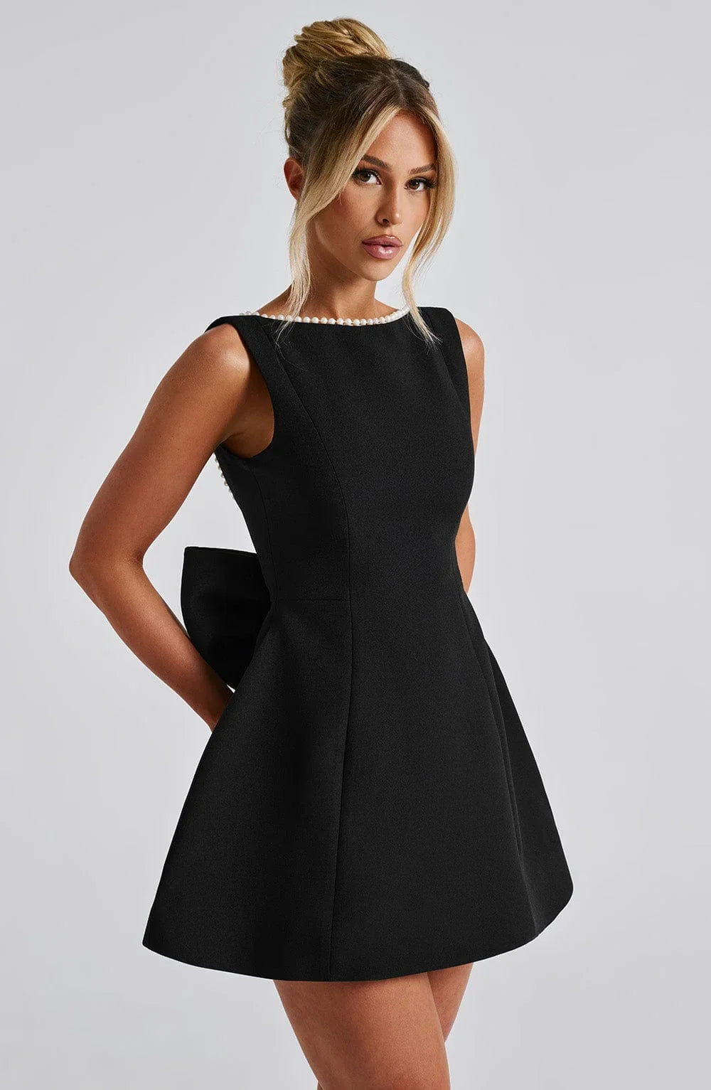 Short women's dress with decorative bow at the back