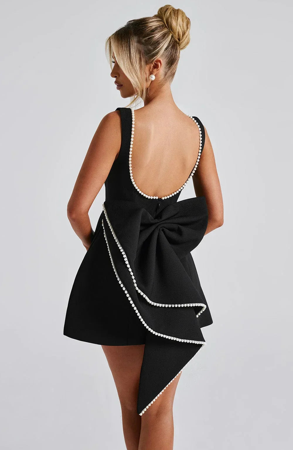 Short women's dress with decorative bow at the back