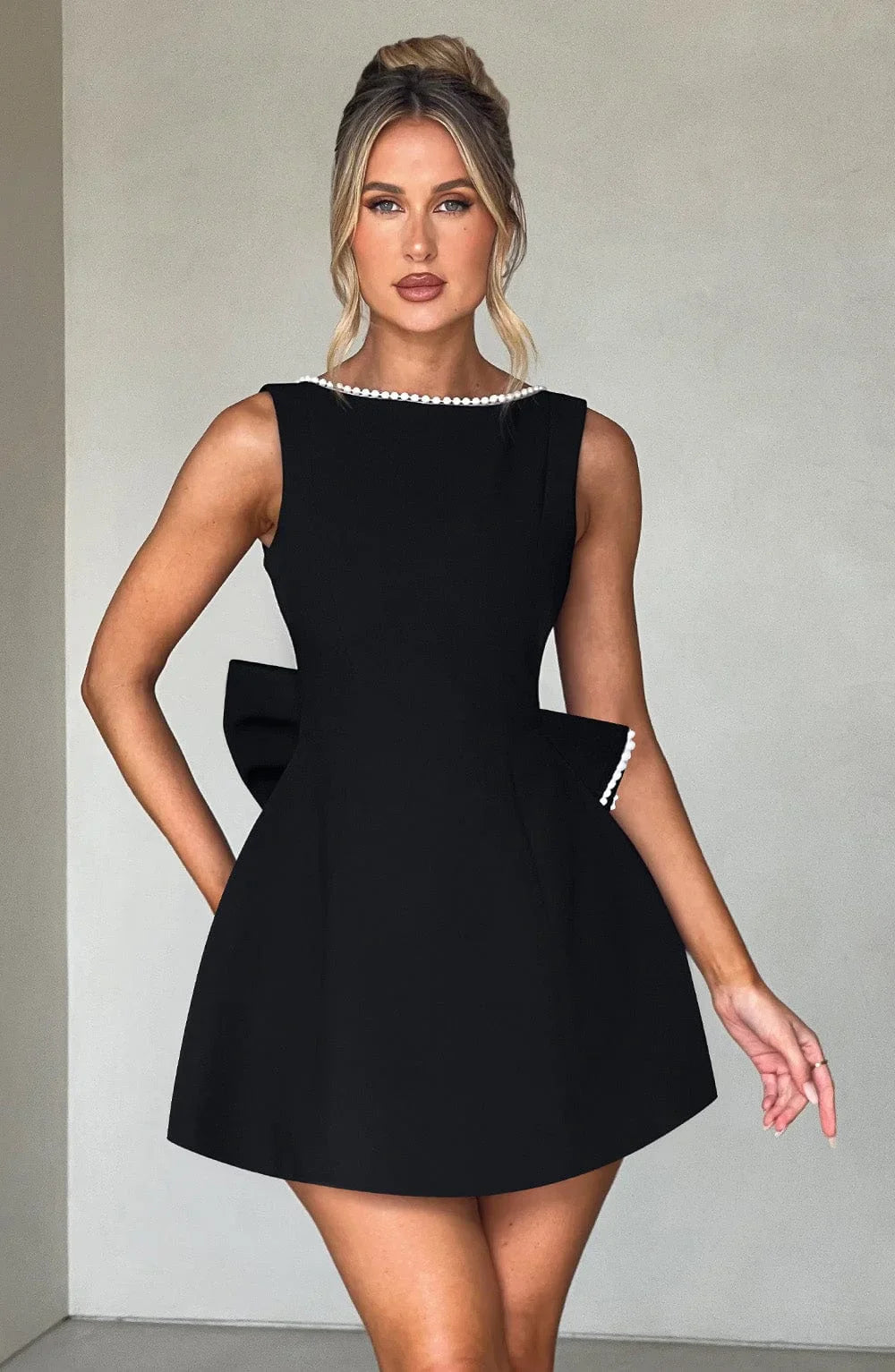 Short women's dress with decorative bow at the back