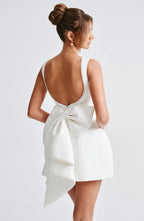 Short women's dress with decorative bow at the back