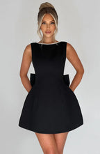 Short women's dress with decorative bow at the back