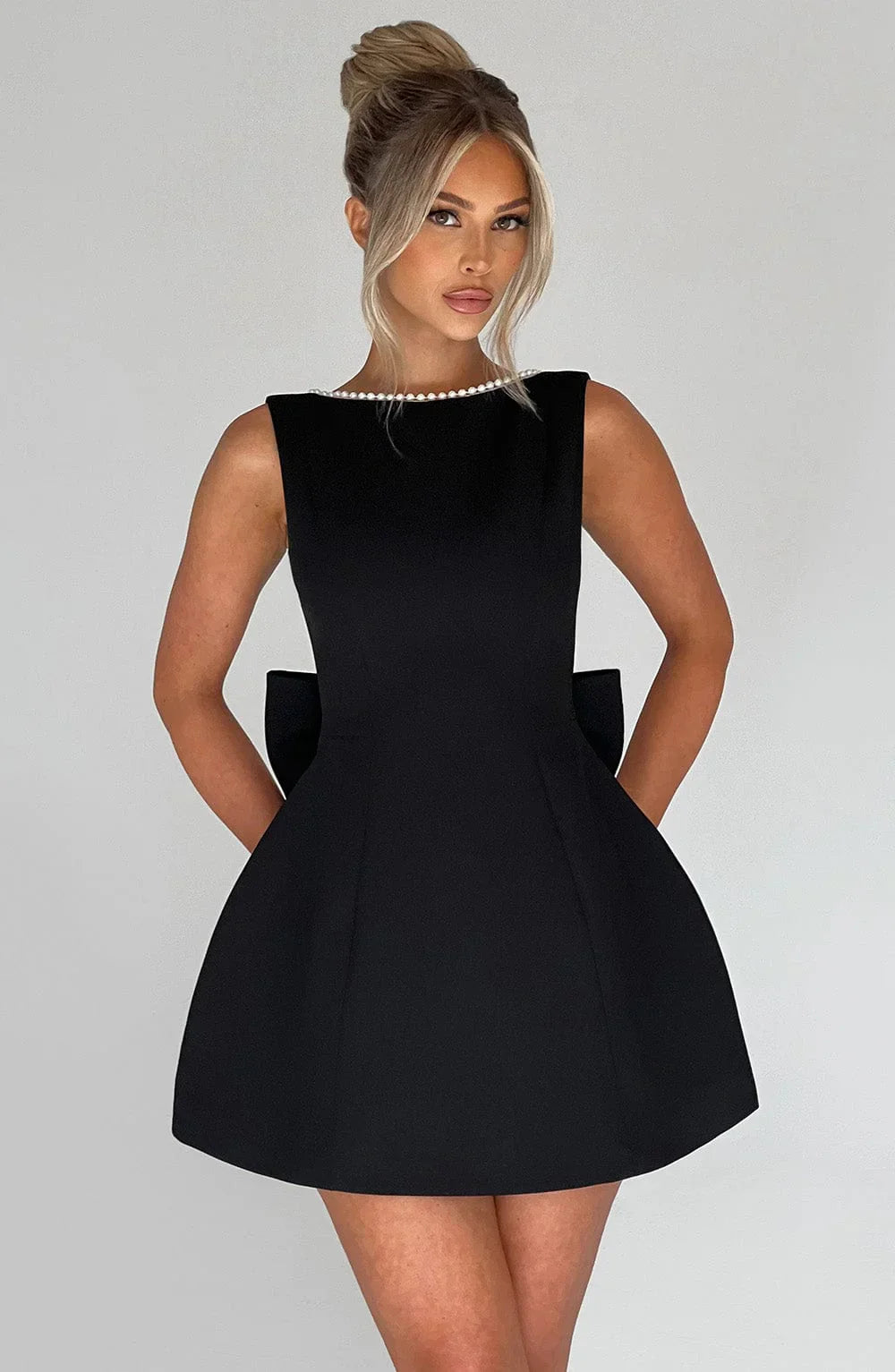 Short women's dress with decorative bow at the back
