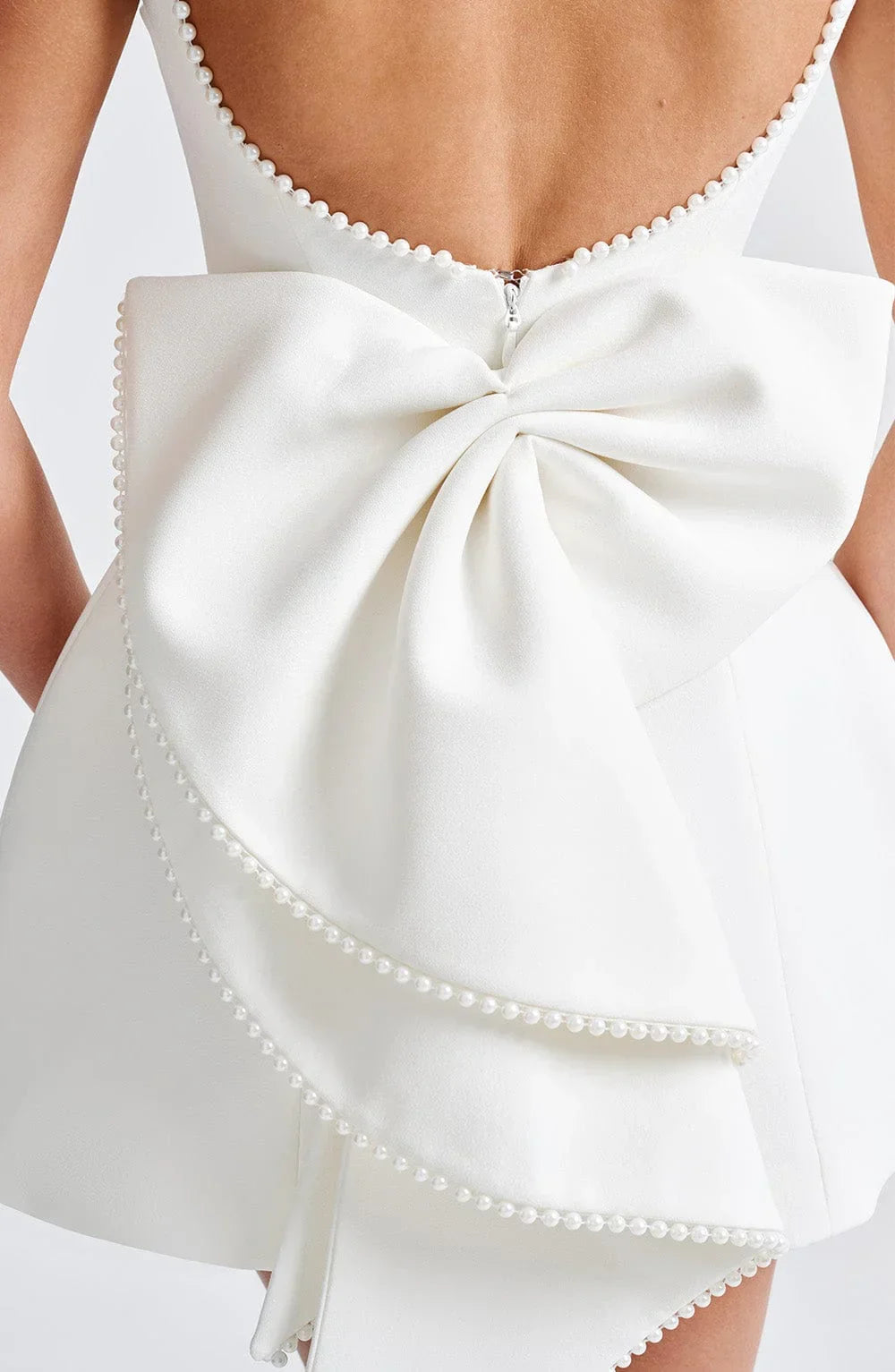 Short women's dress with decorative bow at the back