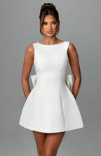 Short women's dress with decorative bow at the back