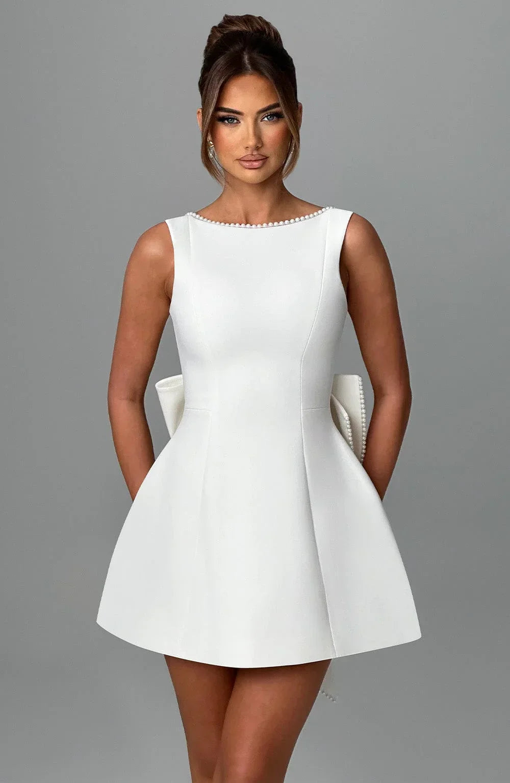 Short women's dress with decorative bow at the back