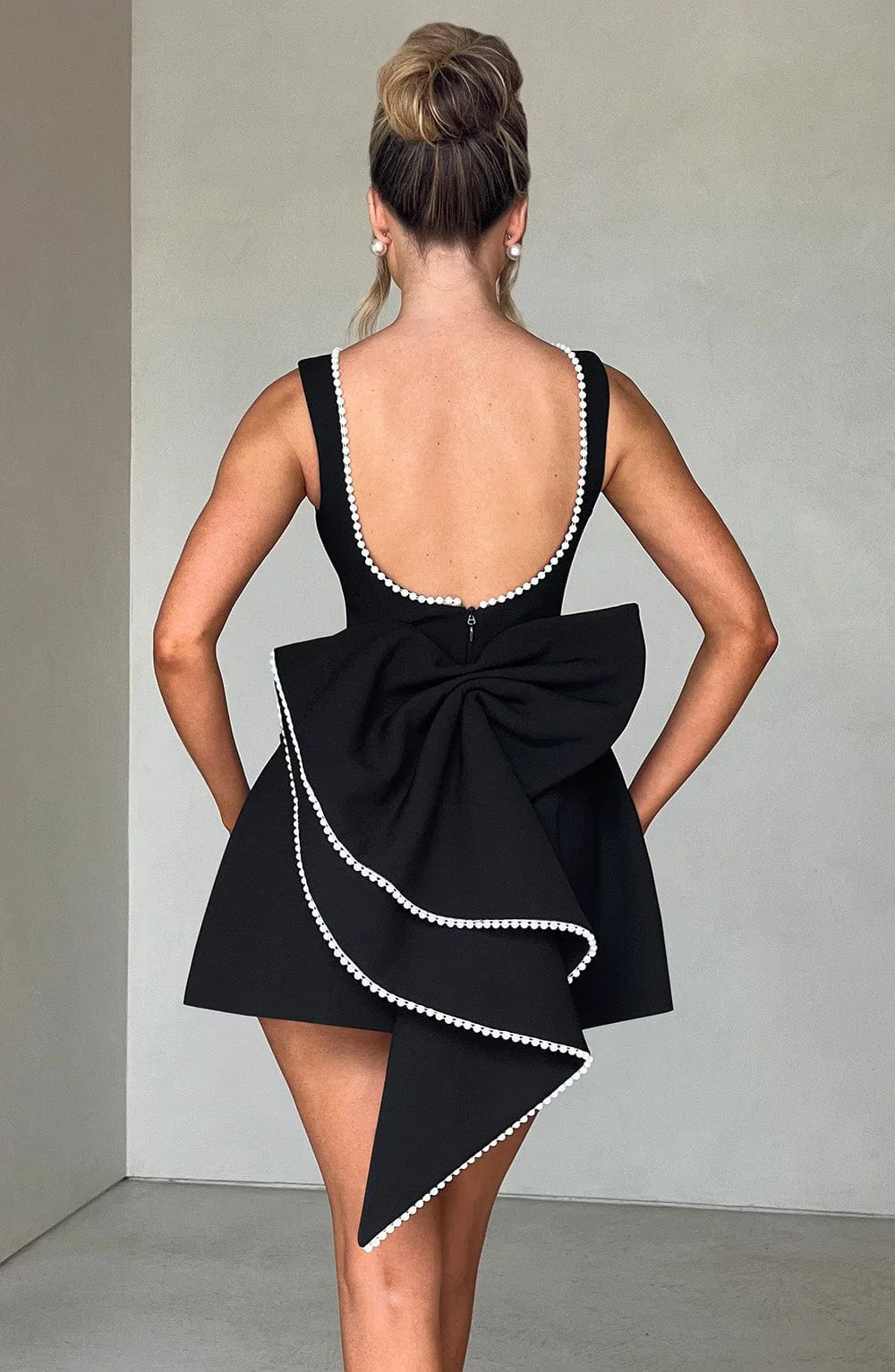 Short women's dress with decorative bow at the back
