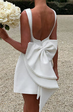 Short women's dress with decorative bow at the back