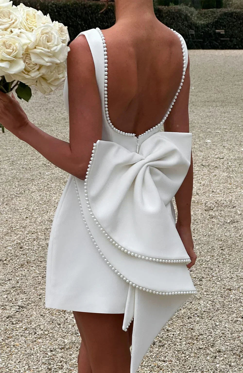 Short women's dress with decorative bow at the back