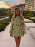 Short women's dress in light green with ruffles and long sleeves for evening wear