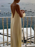 Long yellow backless dress for summer beach relaxation