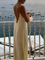 Long yellow backless dress for summer beach relaxation