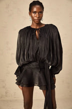 Short fluid dress with long sleeves and tied belt