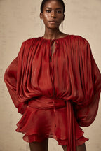 Short fluid dress with long sleeves and tied belt