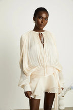 Short fluid dress with long sleeves and tied belt
