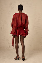 Short fluid dress with long sleeves and tied belt