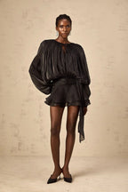 Short fluid dress with long sleeves and tied belt