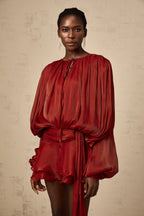 Short fluid dress with long sleeves and tied belt