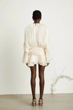 Short fluid dress with long sleeves and tied belt